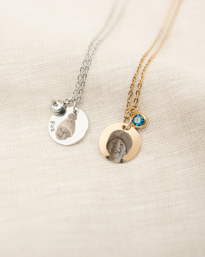 Two necklaces with photo charms on a beige background