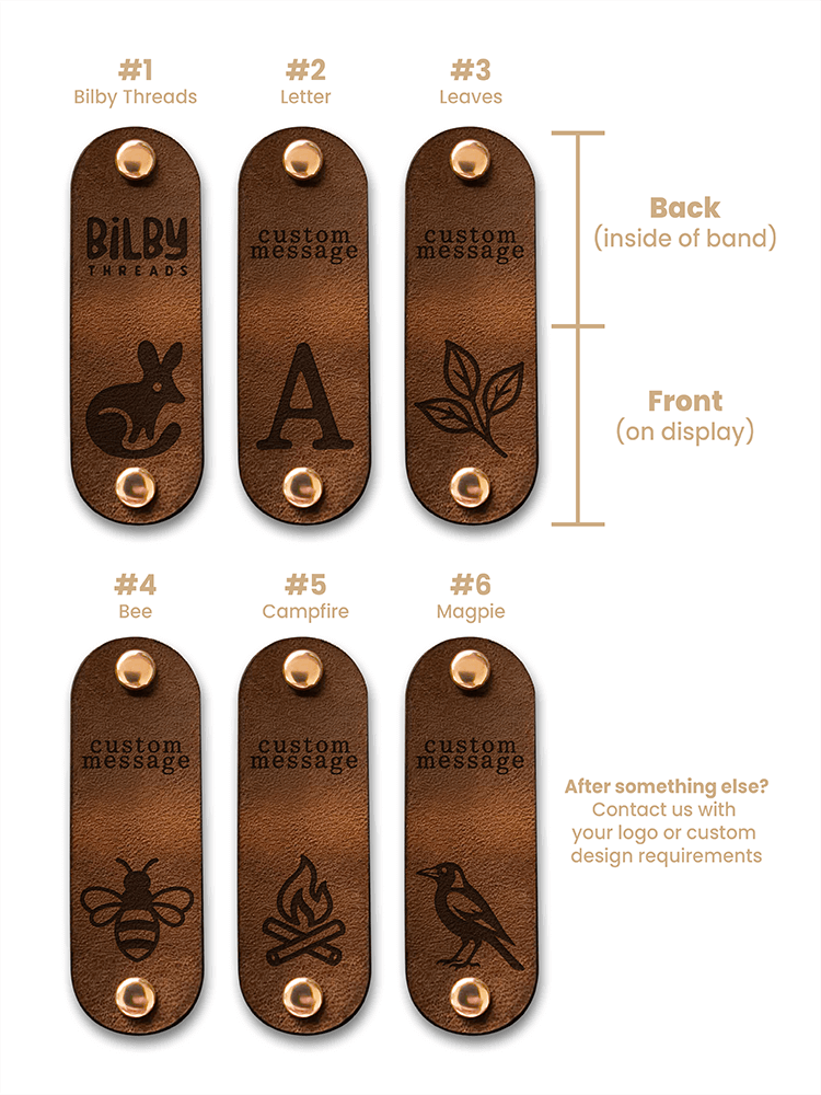 Set of wooden tags with engraved designs and text, showing front and back views.